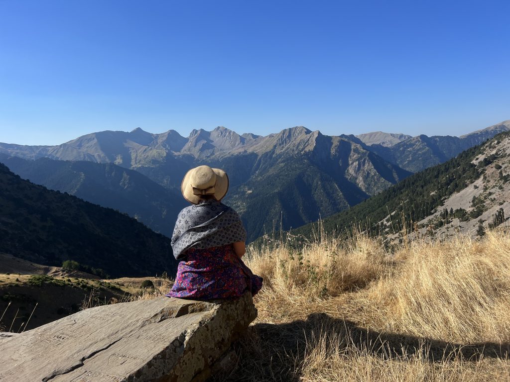 Girl overlooking Agrafa mountain range at a mountain top