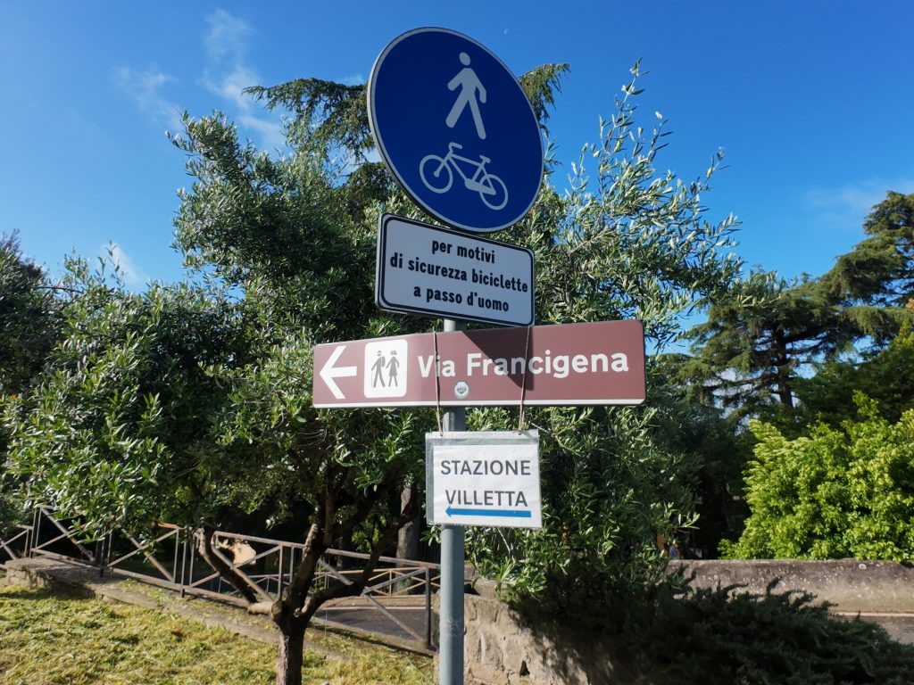 Via Francigena signs on road hiking paths