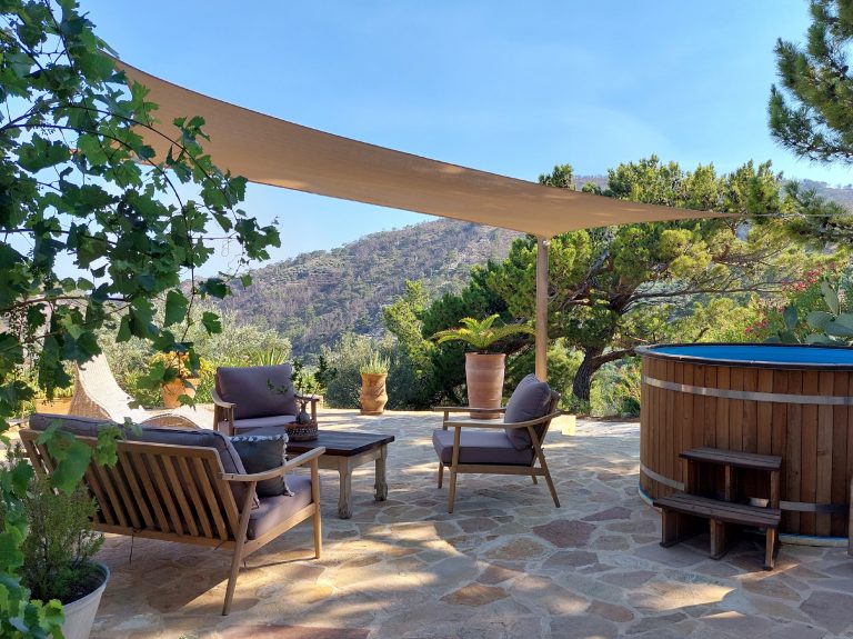 Cretan eco farm living outdoor mountain views and cool tub with blue waters